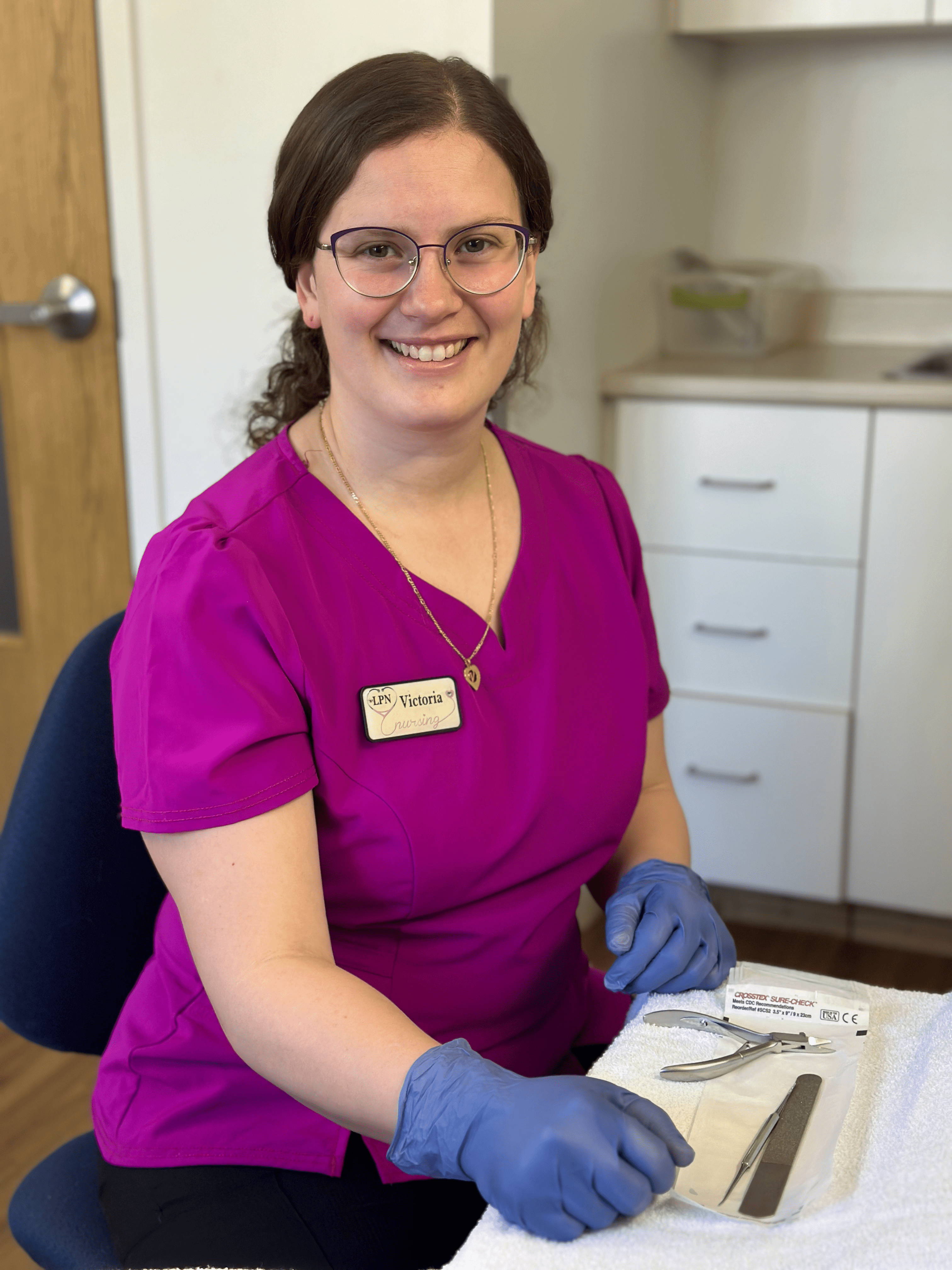 Nurse Victoria with foot care instruments in front of her.